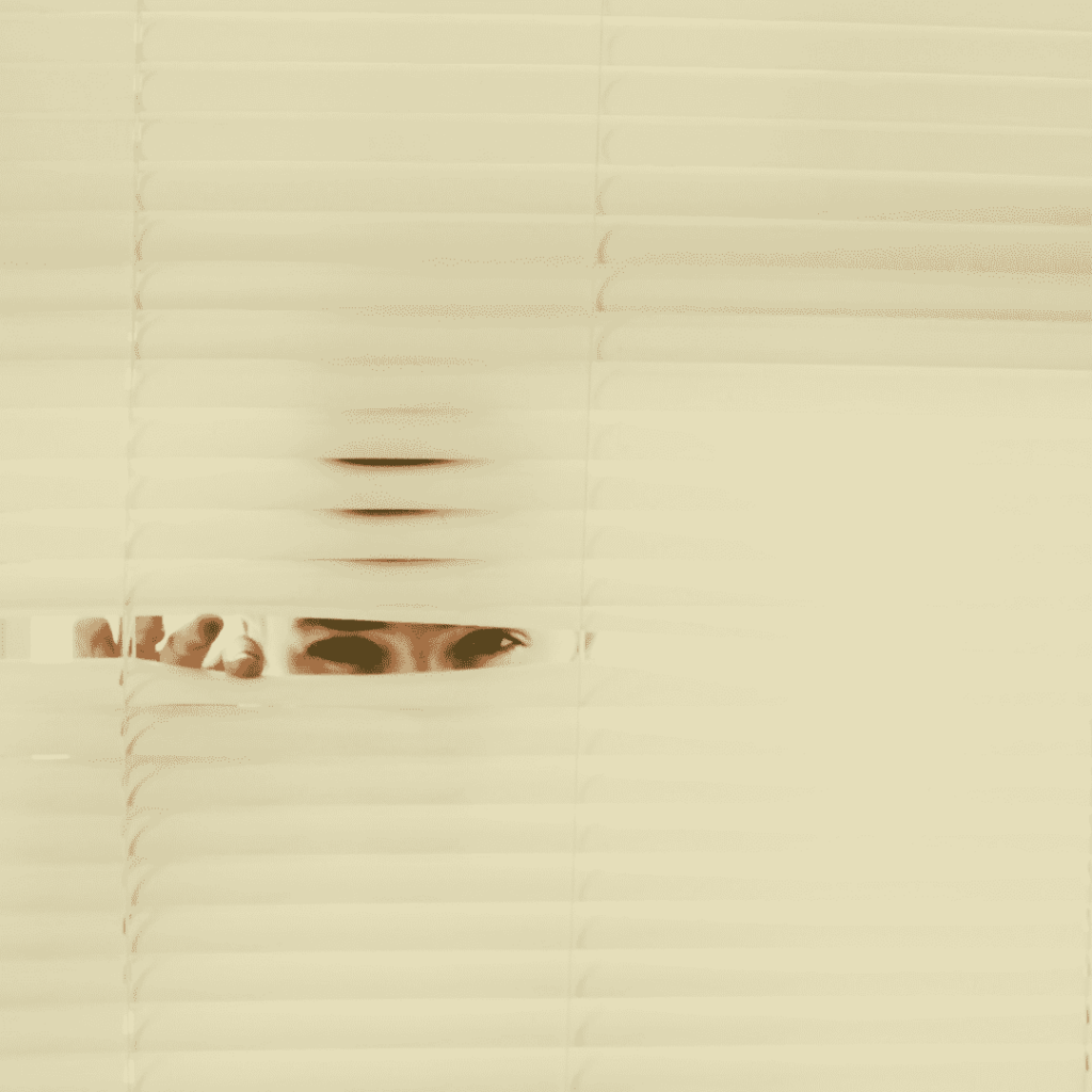 A man peaking between blinds for Privacy Policy page